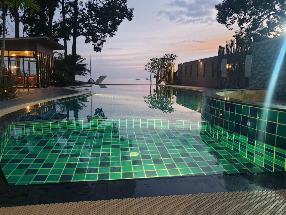Green-lit pool tiles glowing at dusk