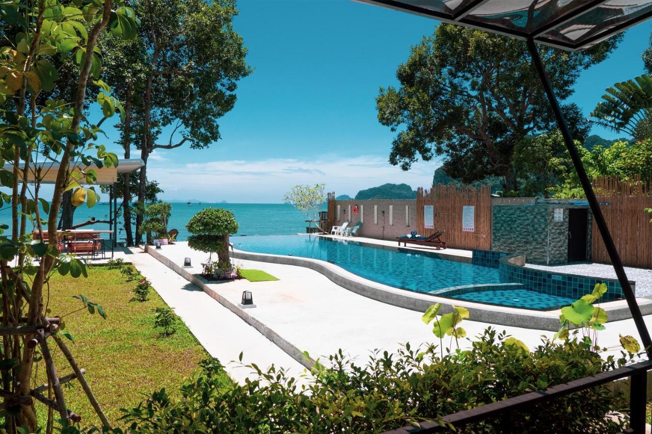 Infinity pool overlooking the Andaman Sea and Krabi karsts, framed by tropical greenery